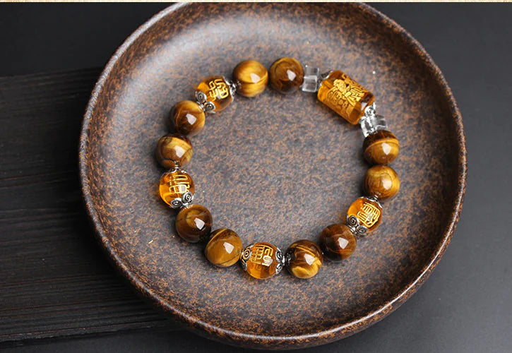 Bracelet with tiger eye stones on a rustic plate